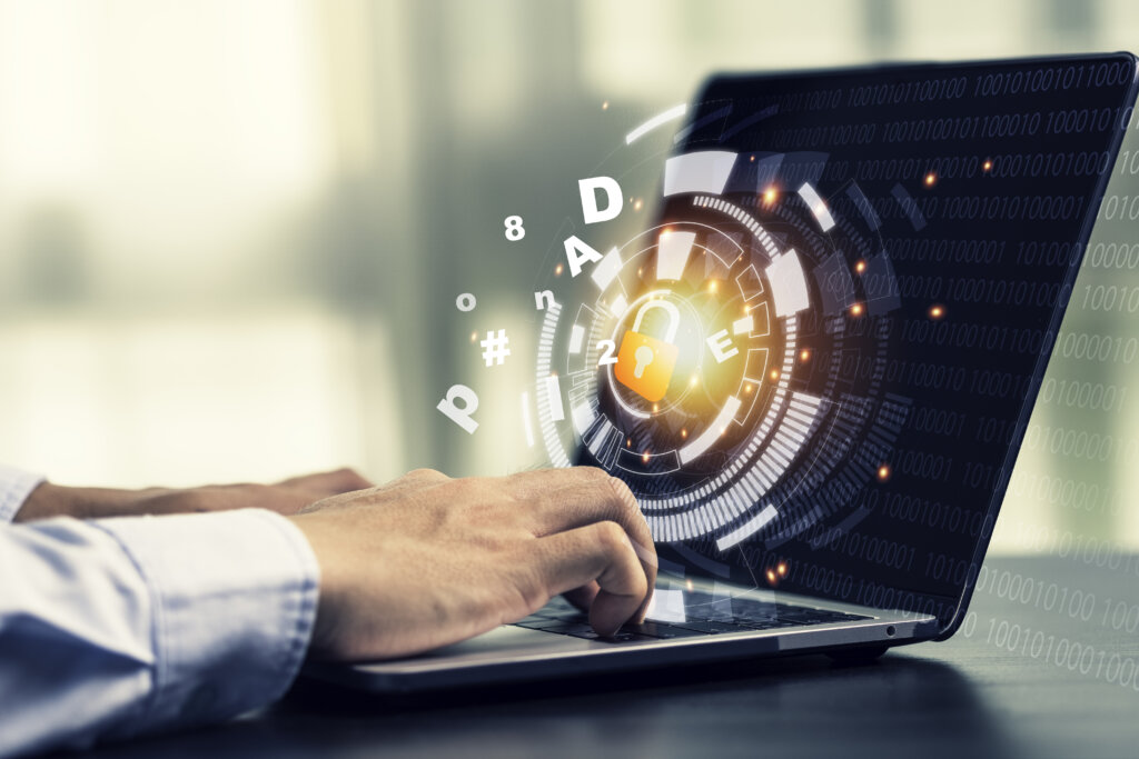 User typing on laptop with digital cybersecurity lock and password protection interface